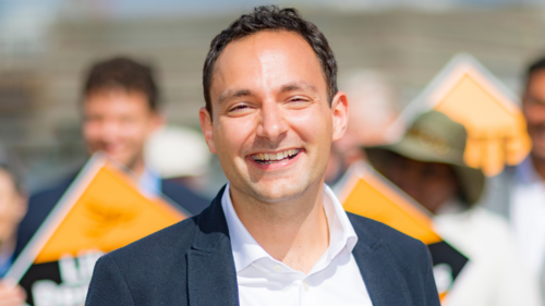 Blaise standing in front of a crowd of Liberal Democrat campaigners